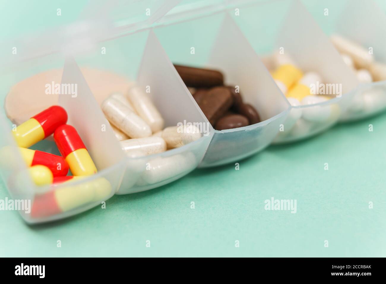 Seven day pill box with pills isolated Stock Photo