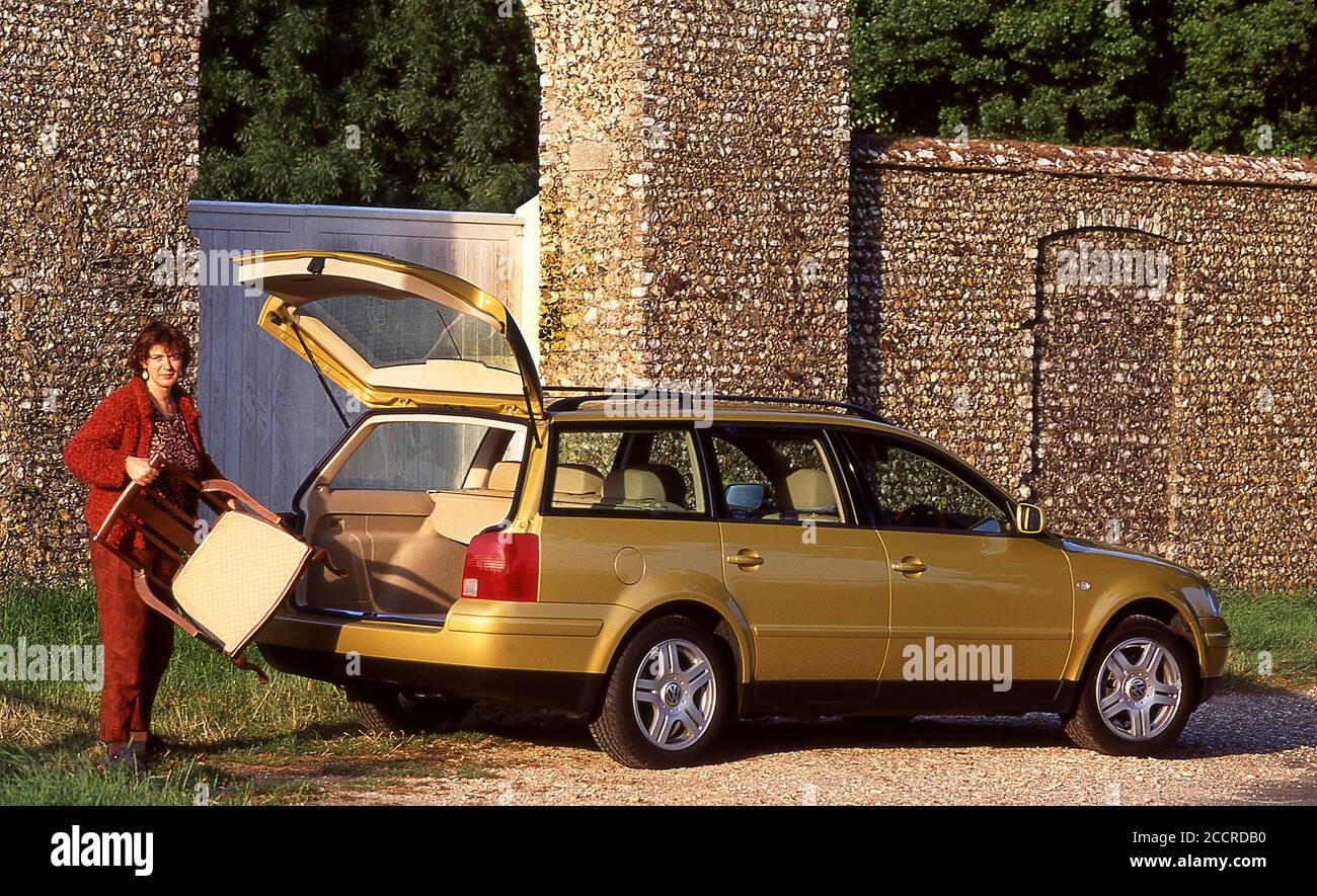 1999 VW Passat Estate car, Woman loading furniture in to the luggage
