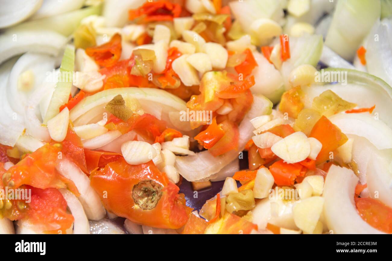 A salad prepared in a Brazilian restaurant with sliced onions, red tomatoes, garlic and chopped peppers. Southern Brazilian cuisine. Stock Photo