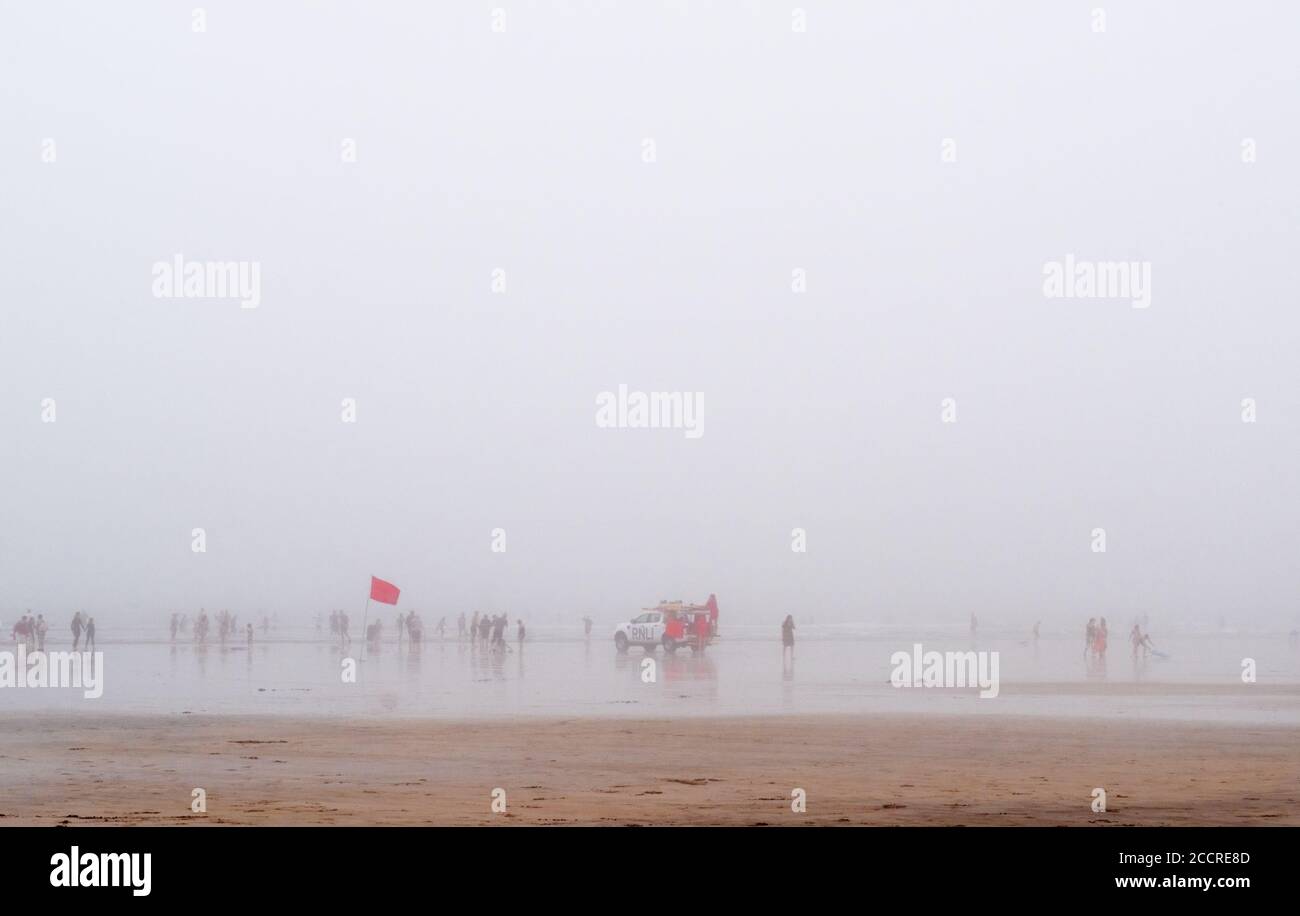 Fog on Westward Ho! beach. With red flag and RNLI. August 2020. Stock Photo