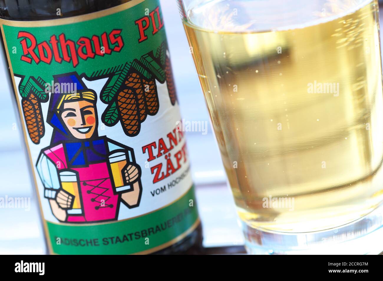 A bottle of German beer brand Rothaus Pils Tannenzapfle with beer glass Stock Photo