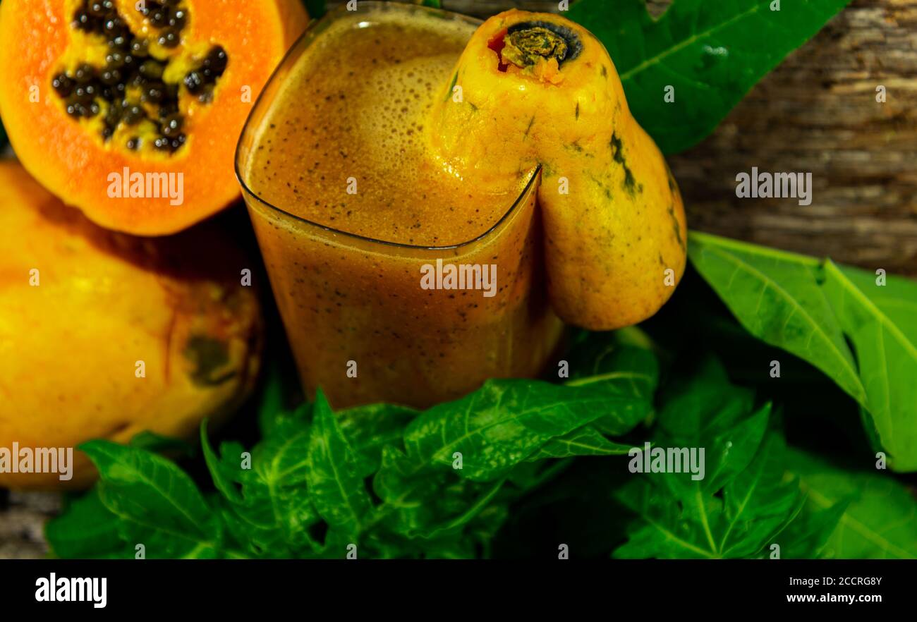 Fresh papaya juice and fruits. Carica papaya L. is a species of tropical fruit that produces the
