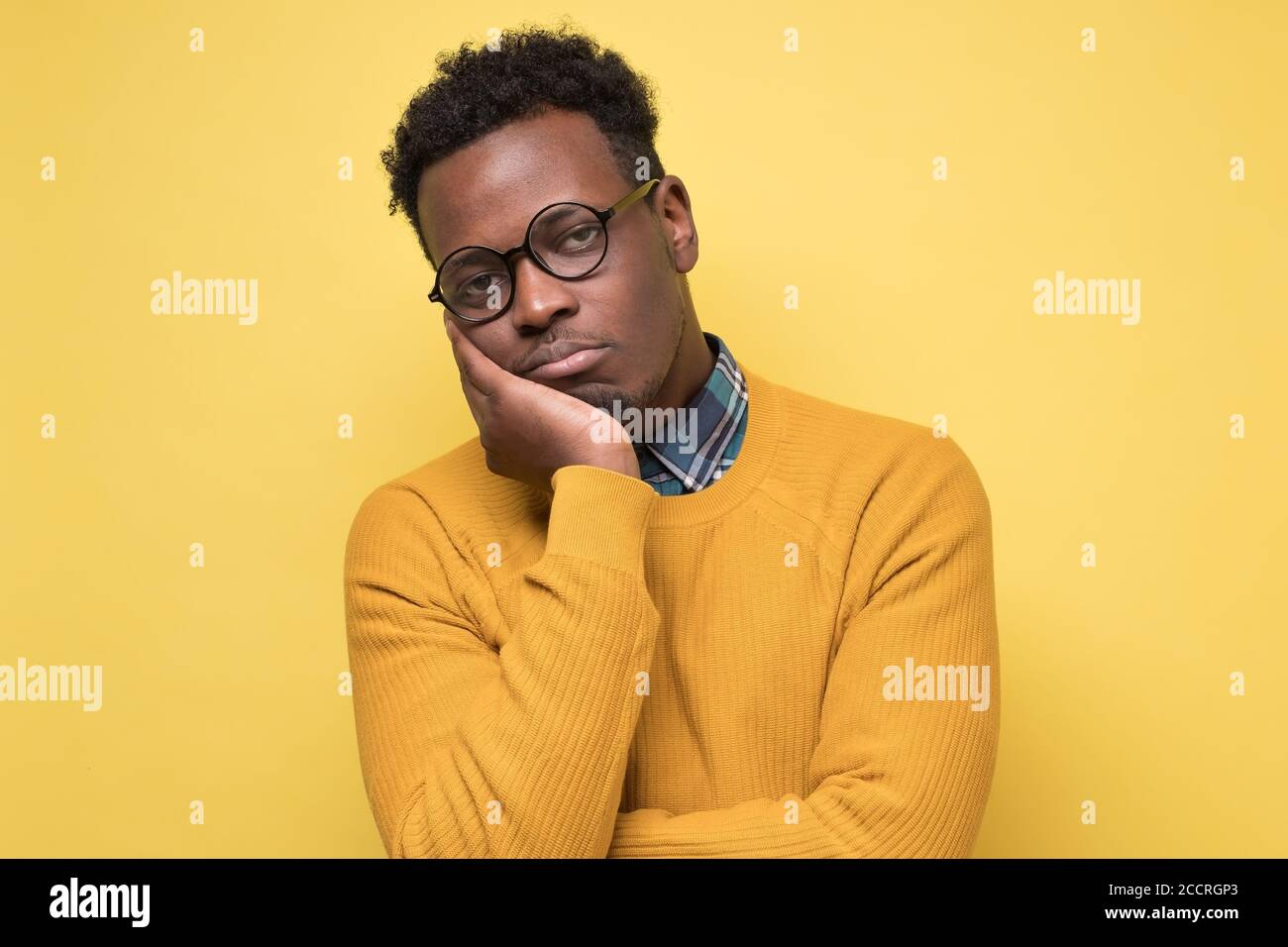 Unhappy frustrated young african man having puzzled expression Stock Photo