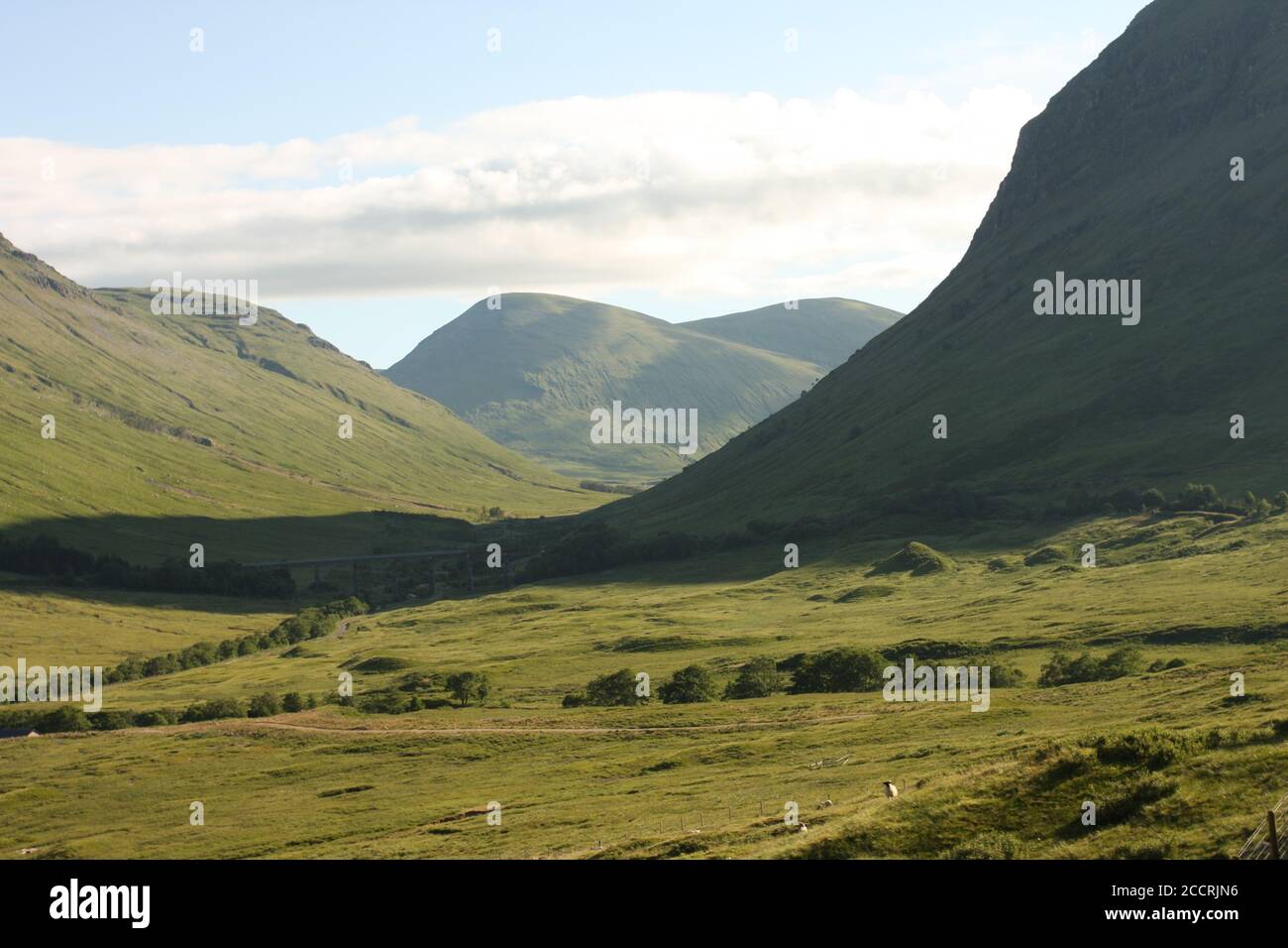 Early morning view of mountains and valley from the Caledonian sleeper train from London to Fort William, Scotland, UK Stock Photo
