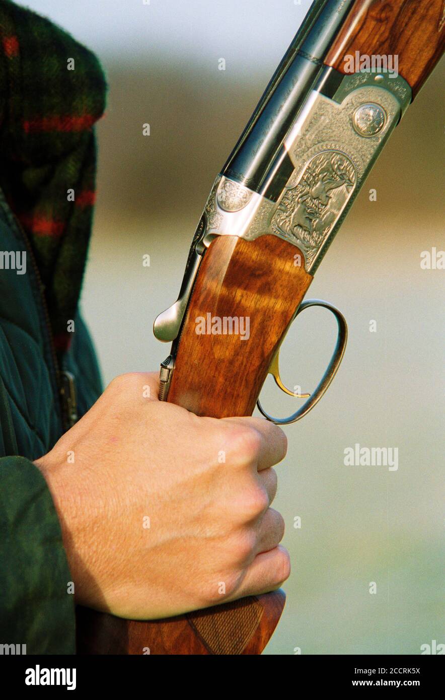Close up of a hand holding a Beretta side by side shotgun.  UK Circa 2001. Stock Photo