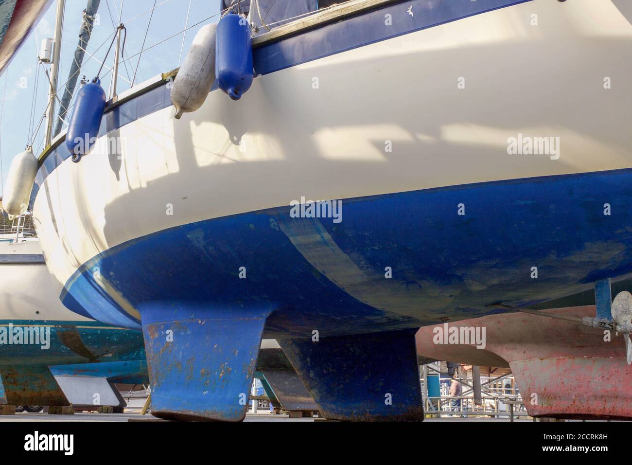 Various hulls of yachts and boats wintering in dry dock Stock Photo - Alamy