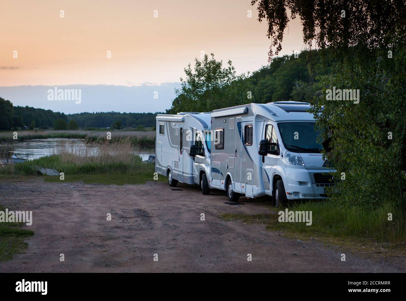 Two motorhomes parked in beautiful nature. Stock Photo