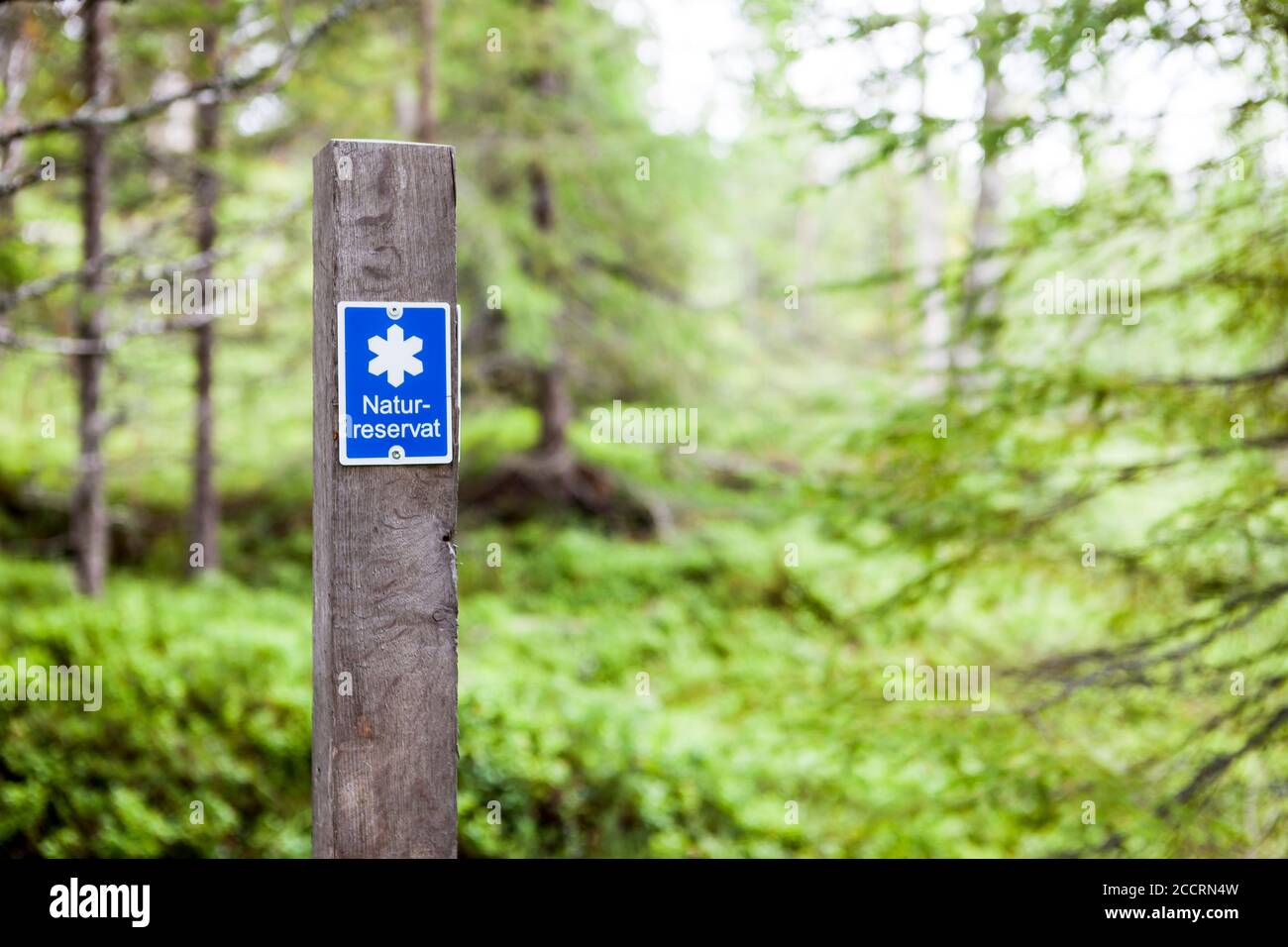 Signpost of the border for a nature conservation park in Sweden. Stock Photo