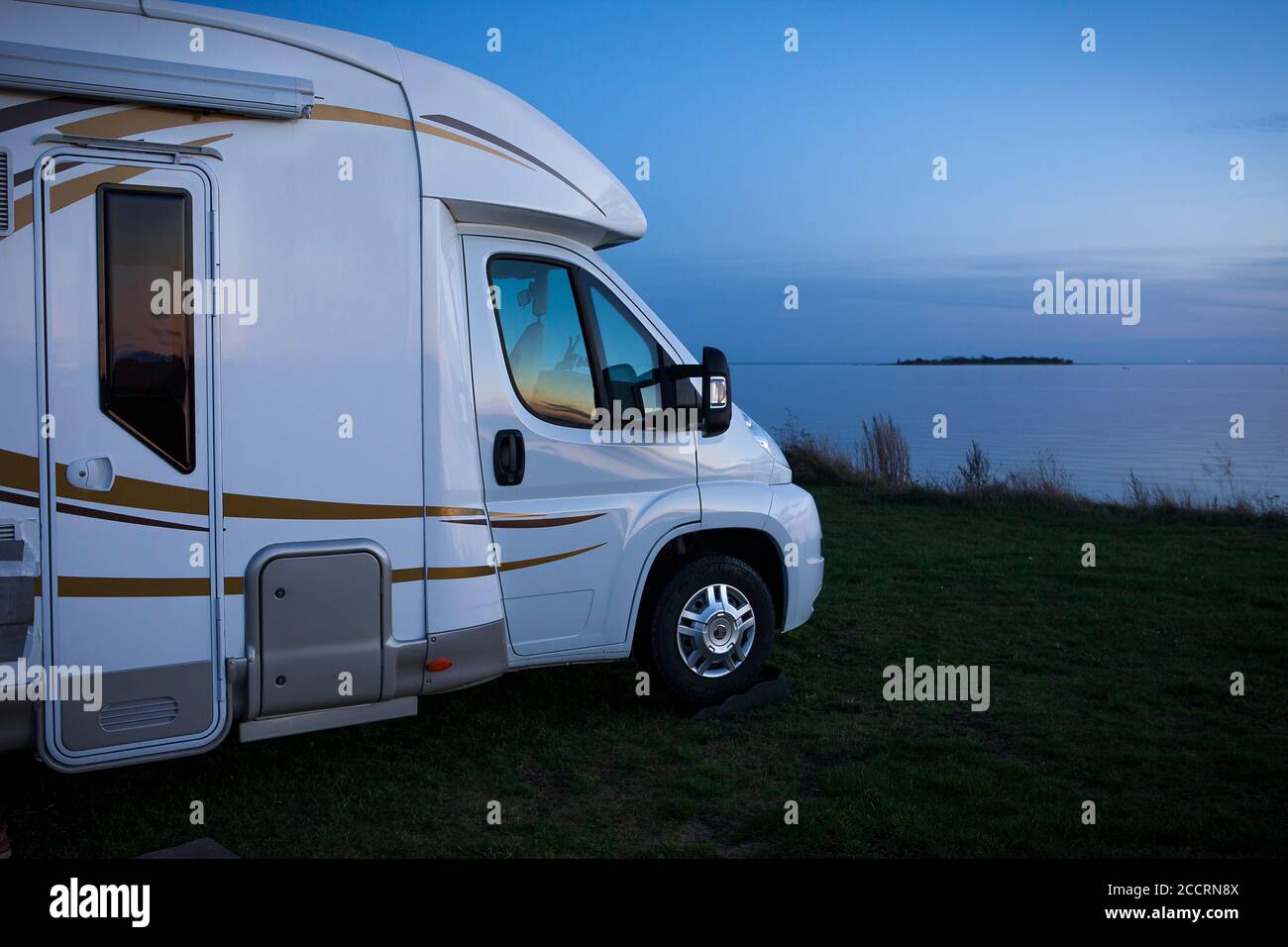 Front of a camping car parked just a couple of meters from the sea. Stock Photo