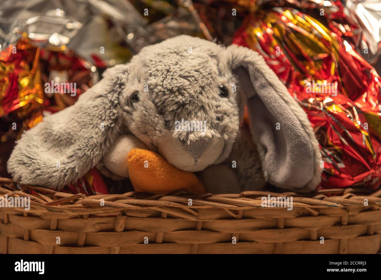 Stuffed rabbit in wicker basket. The Easter Bunny is one of the Easter