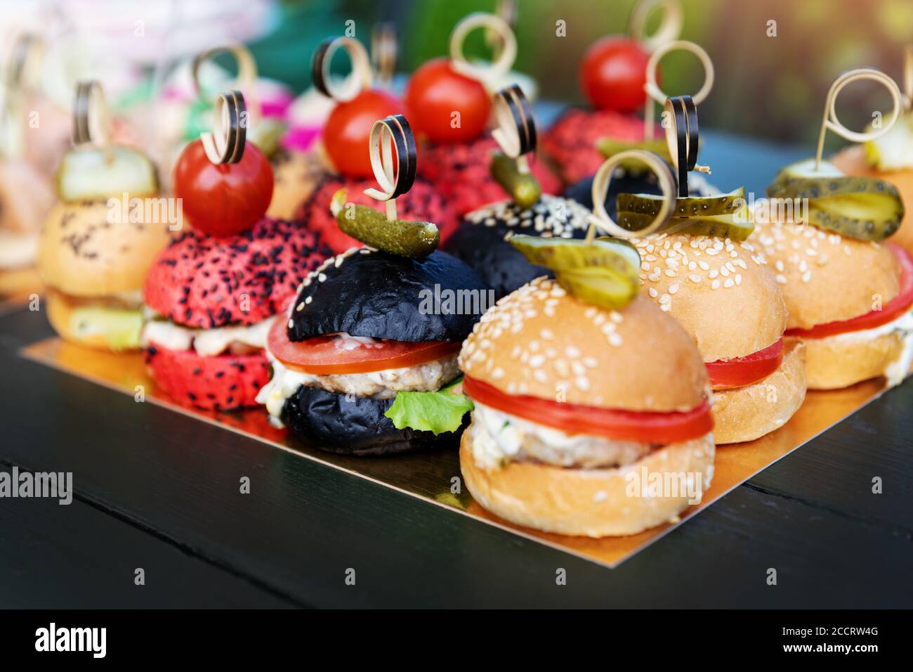 buffet with mini burgers, sliders. catering banquet table with appetizers. party food Stock Photo
