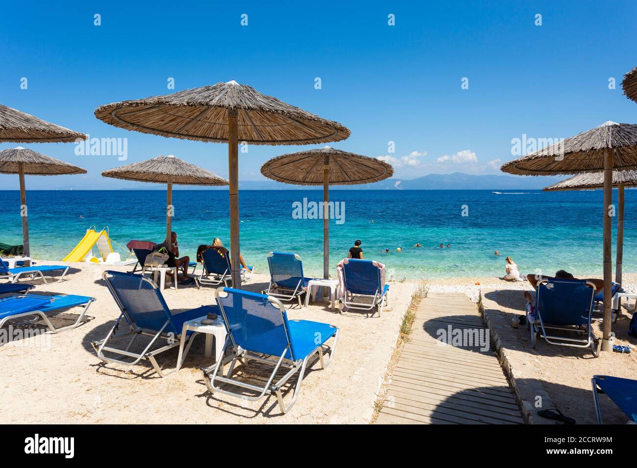 Sun loungers and umbrellas at Kloni Gouli Beach near Gaios, Paxos, Ionian Islands, Greece Stock Photo