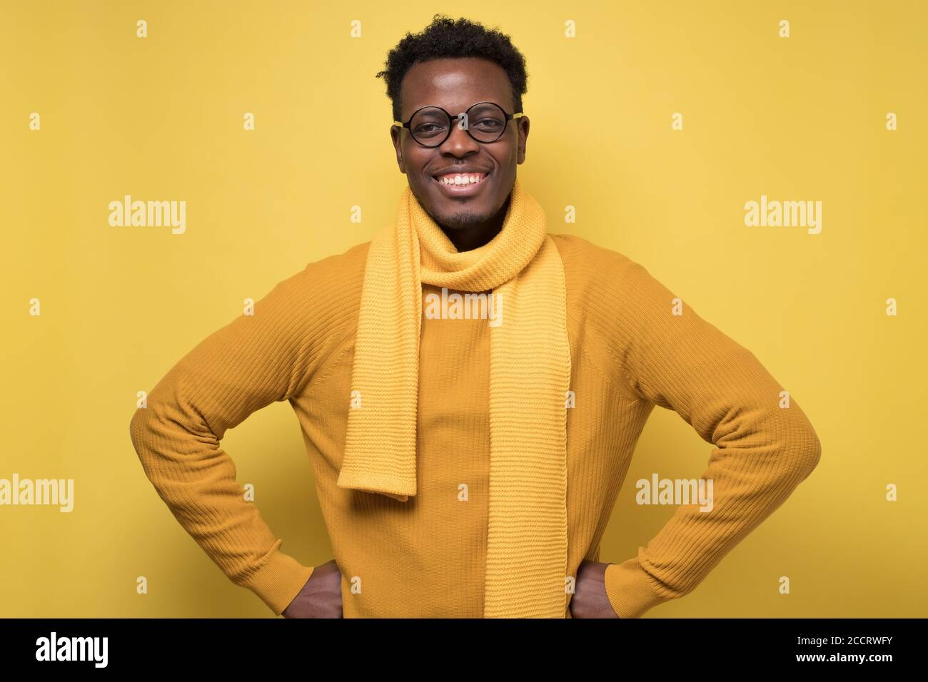 Modern young black man smiling holding with hands on hips Stock Photo