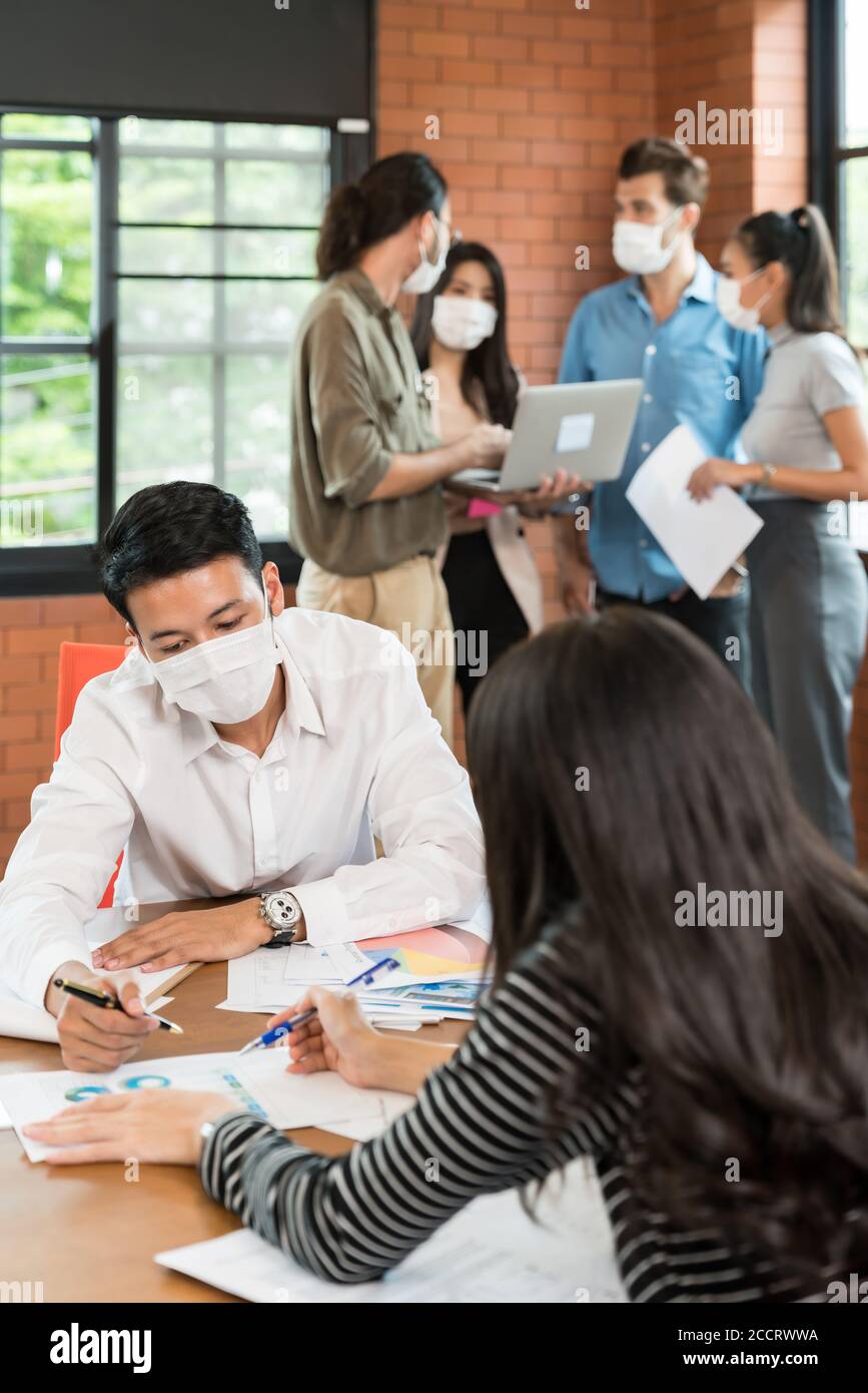 Two business person brainstorm in meeting room with group of ...