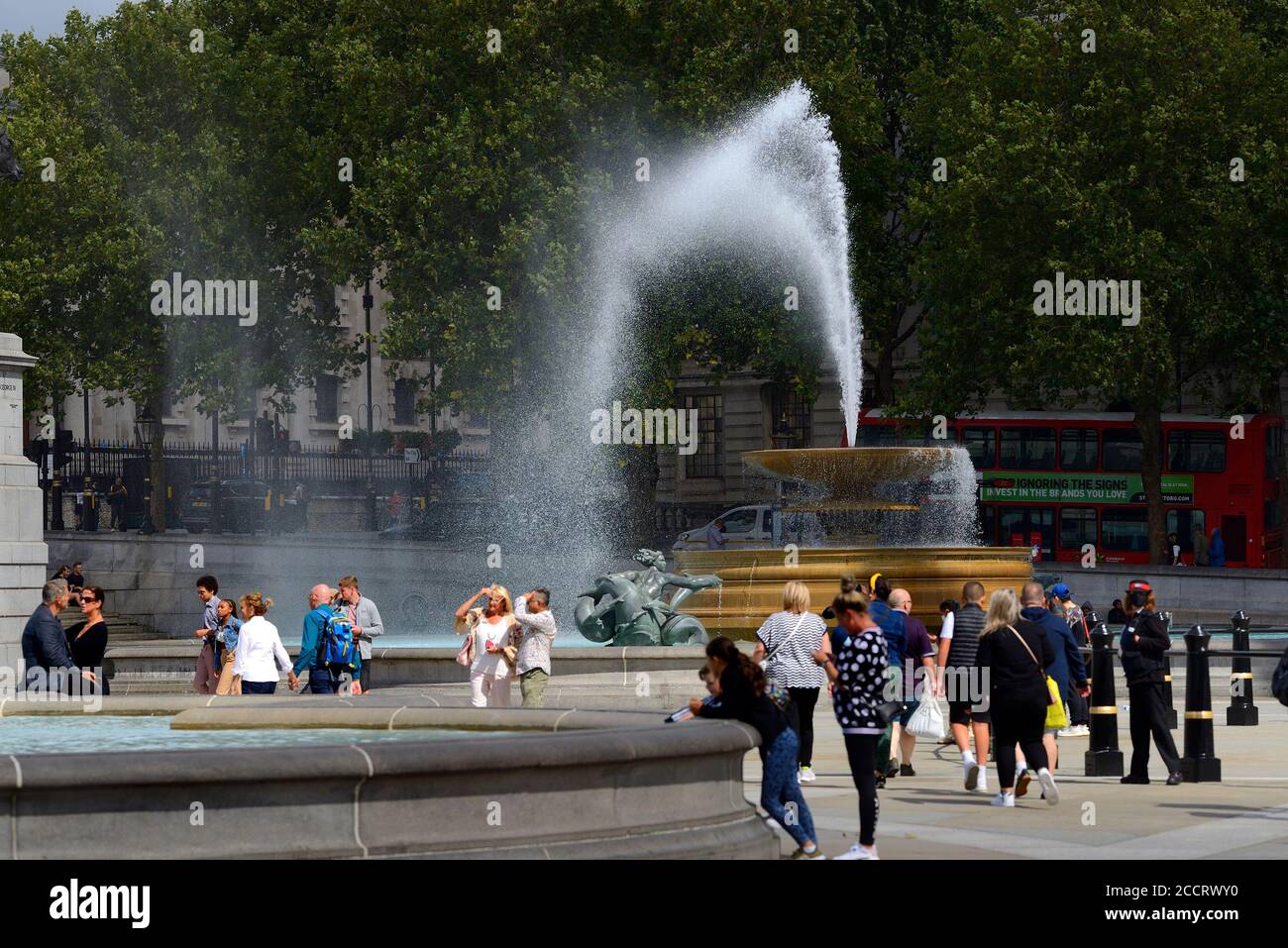 London, England, UK. Trafalgar Square - the water of one of the fountains blown across the square by strong gusting winds, August 2020 Stock Photo