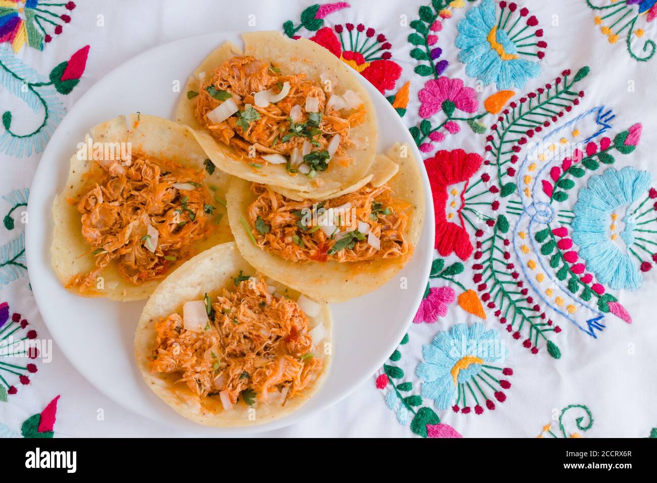 Authentic tinga de pollo tacos on embroidered mexican tablecloth Stock