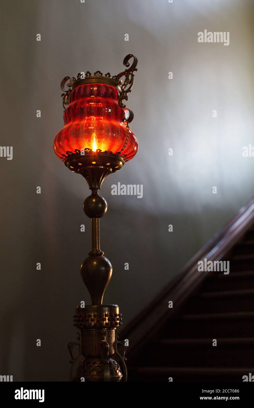 A glass lamp on a newel post, from the 1800s. Stock Photo