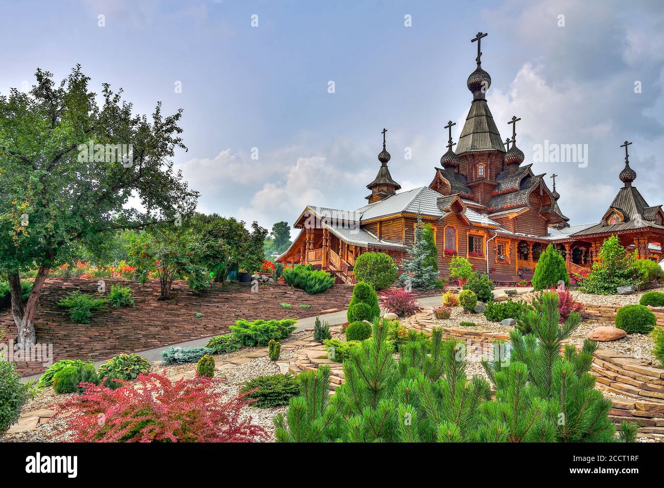 Novokuznetsk, Russia - August 15, 2020: Stony garden with dwarf conifers on front yard of Christian Temple of the Holy Martyr John the Warrior. Beauty Stock Photo