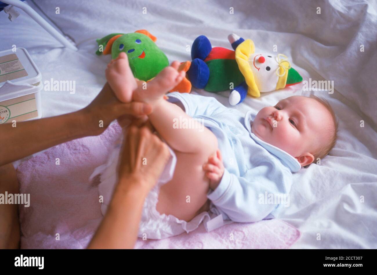 Mother changing babies diaper in bedroom at home Stock Photo Alamy