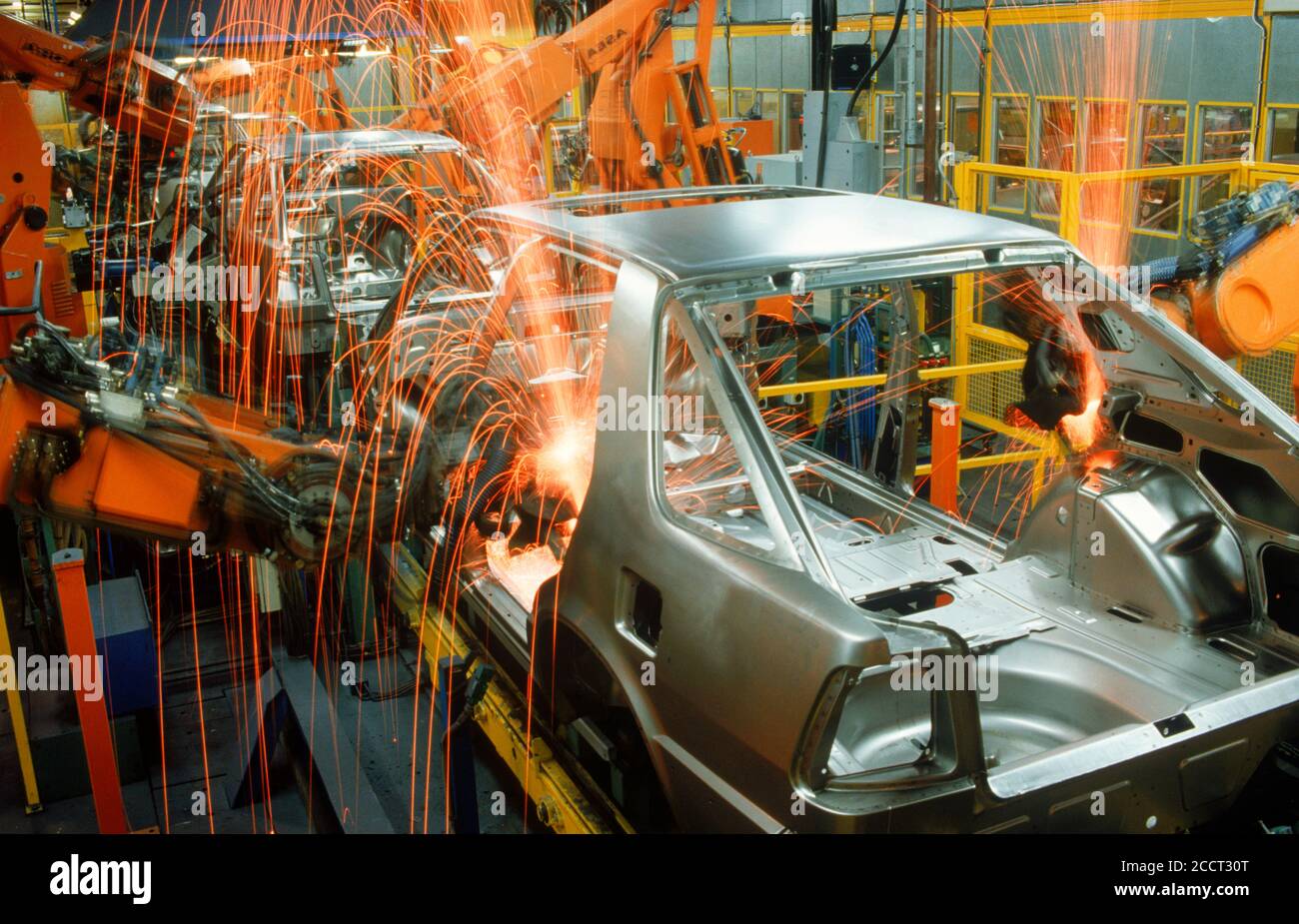 Sparks flying from spot welding robotics in Scania auto plant in Sweden Stock Photo