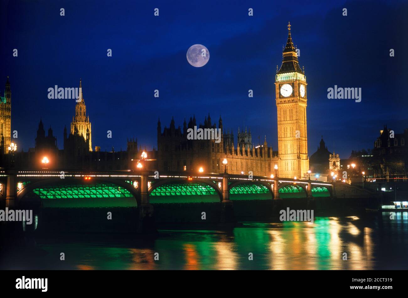 Big Ben and Westminster Bridge with full moon over River Thames at night Stock Photo