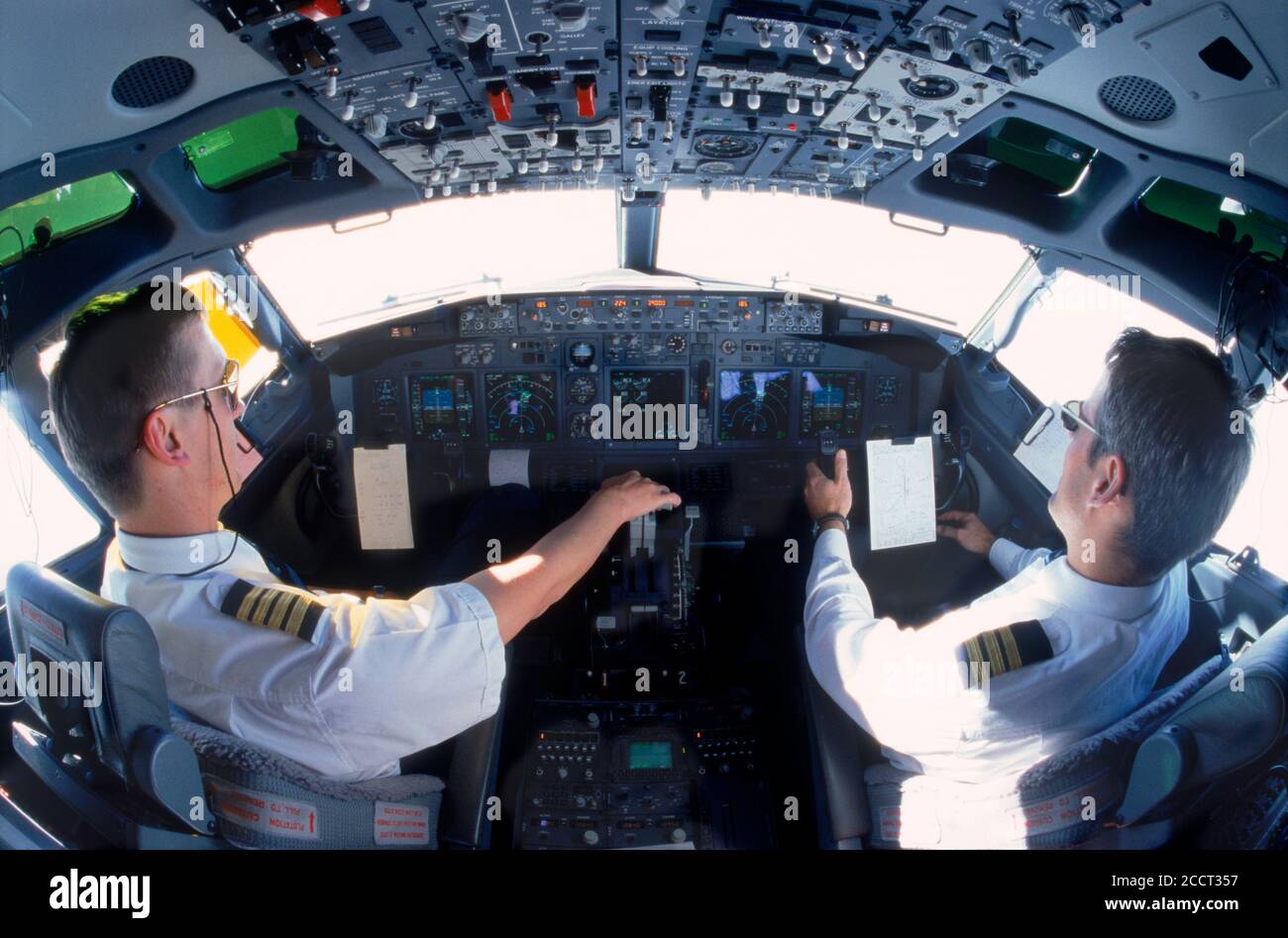 Pilots in cockpit of passenger jet during flight Stock Photo