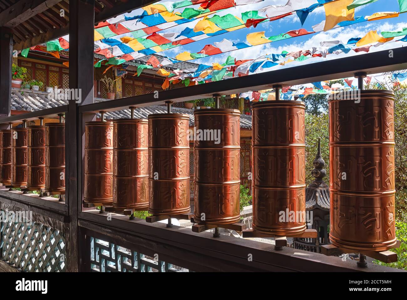 Prayer wheels in Yufeng Temple near Lijiang, China. According to the Tibetan Buddhism spinning such a wheel will havethe same effect of prayers Stock Photo