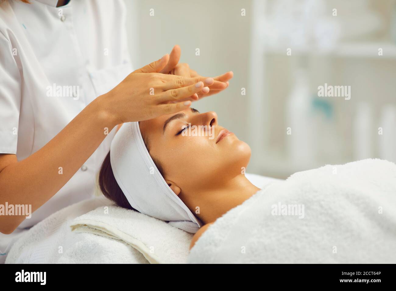 Facial massage.Beautician makes anti-age massage to a woman in a beauty salon Stock Photo