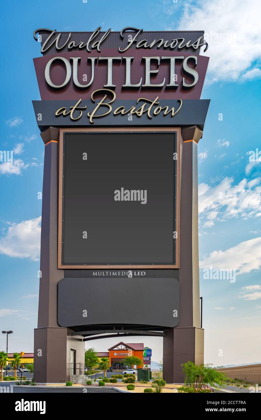 Barstow, CA / USA – August 22, 2020: Large marquee signage for The Outlets at Barstow located adjacent to Interstate 15 in Barstow, California. Stock Photo
