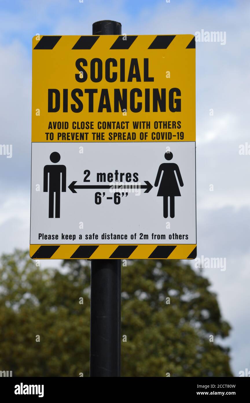 London, UK. 24 August. A social distancing notice lamp posted, reminds the public to maintain a two metres distance to prevent the spread of COVID-19. Stock Photo
