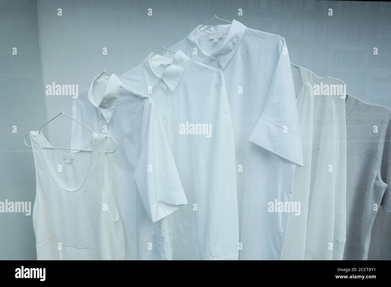White clothes for sale in COS shop window in Brompton Road, London, UK. Stock Photo