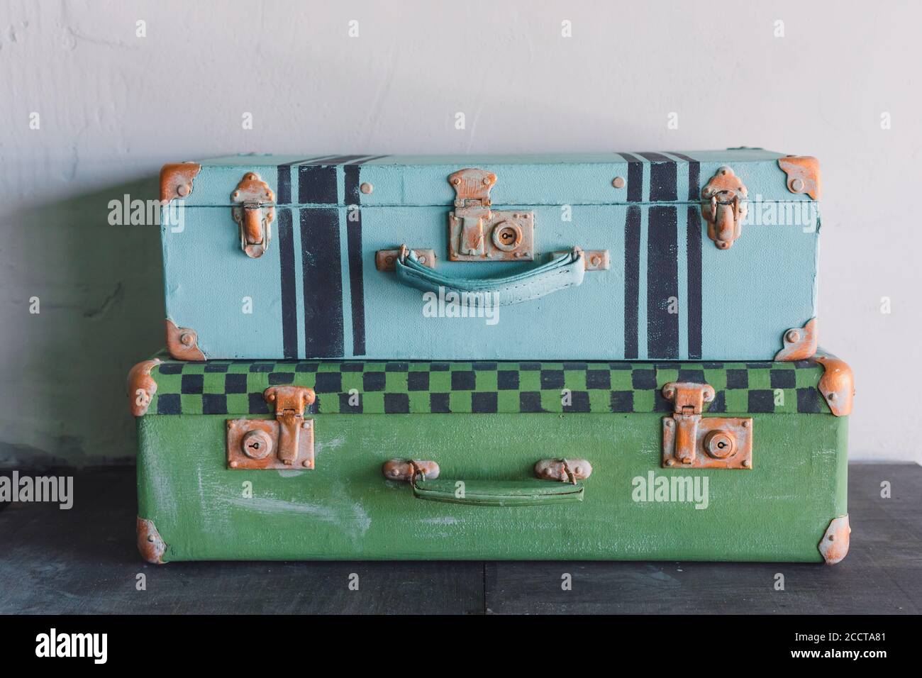 A pair of old vintage colored suitcases, trunks, toned Stock Photo Alamy