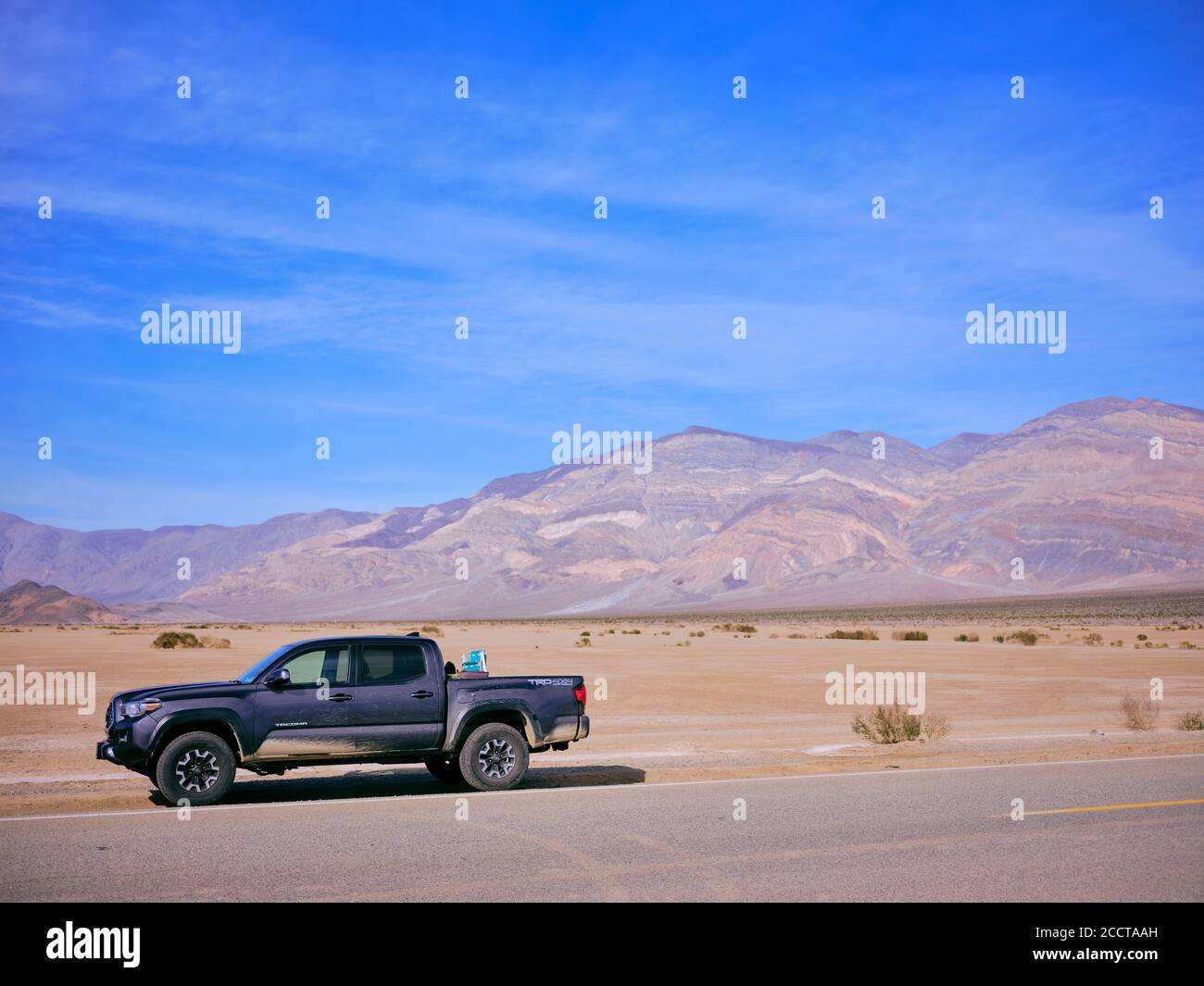 A toyota truck parked on the side of a desert highway, Death Valley Stock Photo