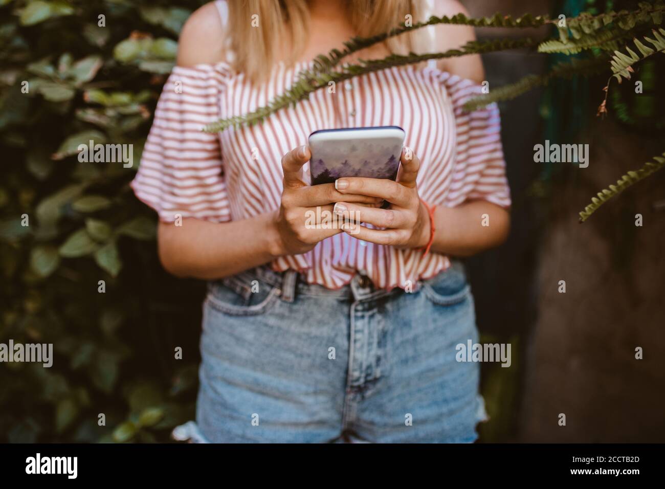 Unrecognizable woman looking her smart phone without mobile coverage Stock Photo