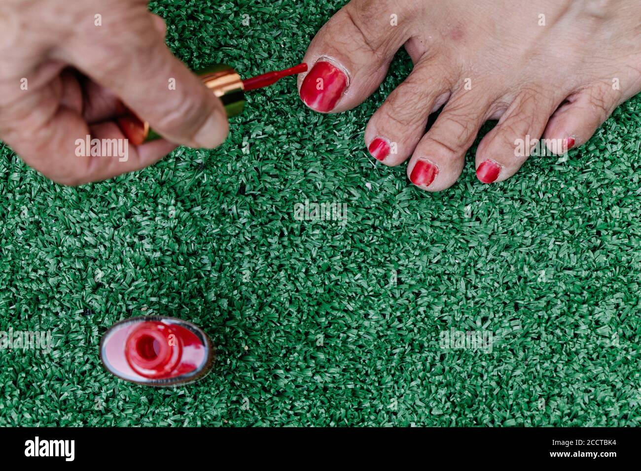 Old man painting his wife's toenails red seen from above Stock Photo Alamy