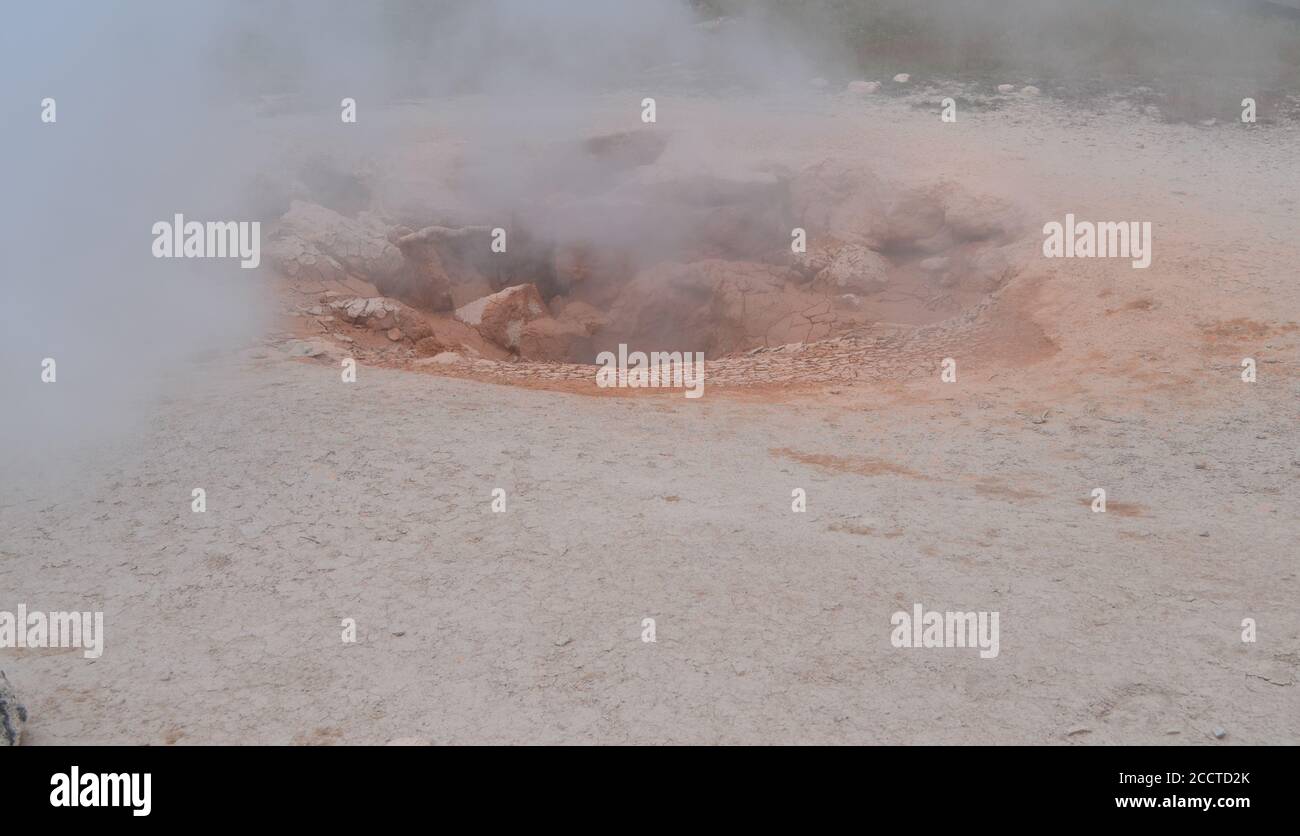 Late Spring in Yellowstone National Park: Looking into the Crater of Red Spouter Mud Pot of the Fountain Group of Lower Geyser Basin Stock Photo