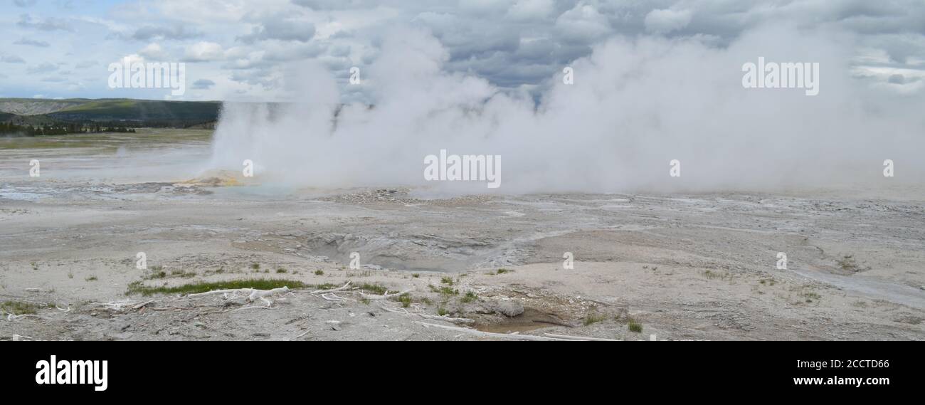 Late Spring in Yellowstone National Park: Spasm Geyser with Clepsydra Geyser Erupting Behind in the Fountain Group of Lower Geyser Basin Stock Photo