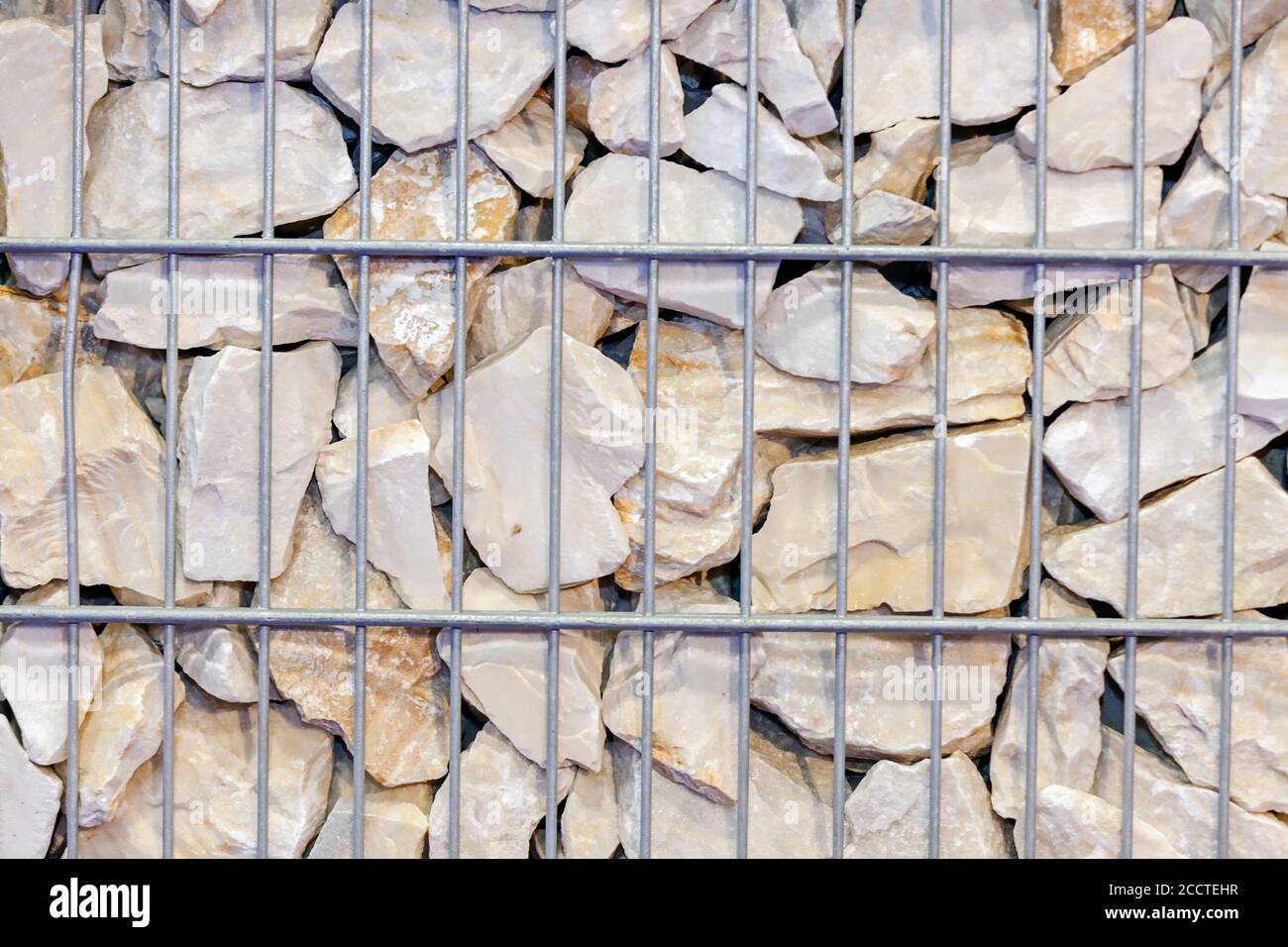 large stones behind wire fences, note shallow depth of field Stock Photo