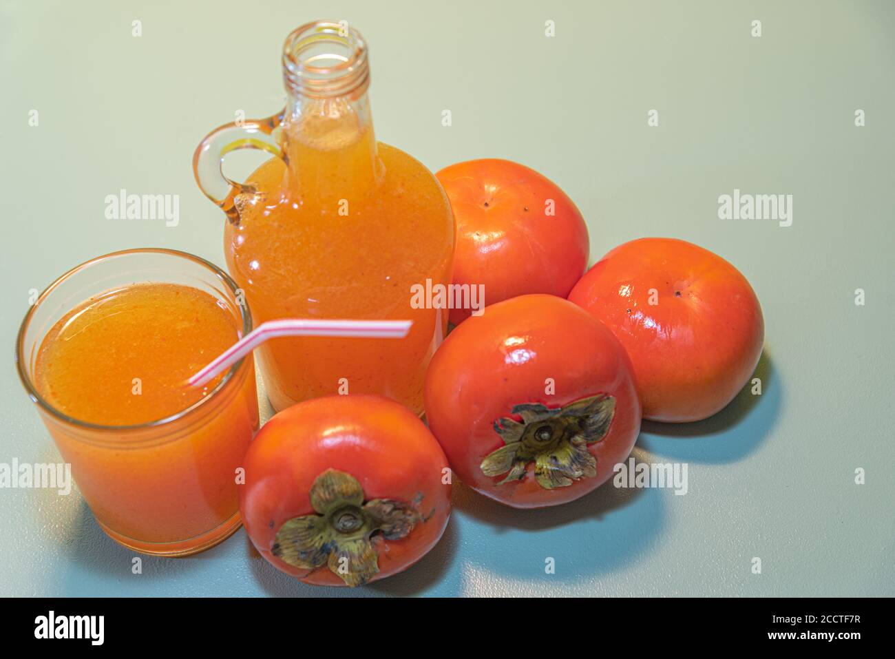 Persimmon fruits and juice. Fiber source. Fruit that favors weight loss. Diospyrus kaki L. The persimmon tree is a tree of Asian origin, worldwide app Stock Photo