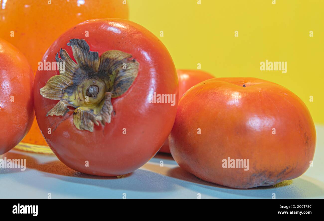 Persimmon fruits and juice. Fiber source. Fruit that favors weight loss. Diospyrus kaki L. The persimmon tree is a tree of Asian origin, worldwide app Stock Photo