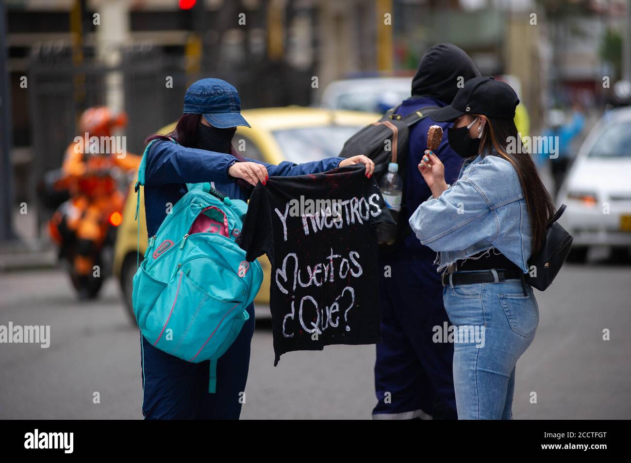 Bogota, Colombia. 23rd Aug, 2020. A demonstrator holds a t-shirt whit a message that reads in spanish 'And our deceased?' during the memorial demonstrations of Dilan Cruz on August 23 2020 in Bogota, Colombia. Dilan Cruz was a high school student who was shot by a riot police officer during the 2019 national strike in Colombia, on the demonstrations that took place on november 23 2019. (Photo by Sebastian Barros Salamanca/Pacific Press/Sipa USA) Credit: Sipa USA/Alamy Live News Stock Photo