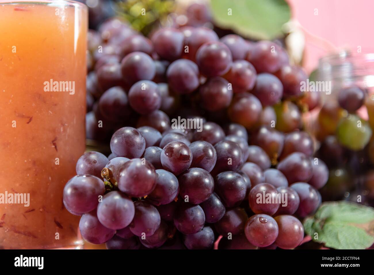 Pot with grains and grape clusters. Grape juice. refreshing drink