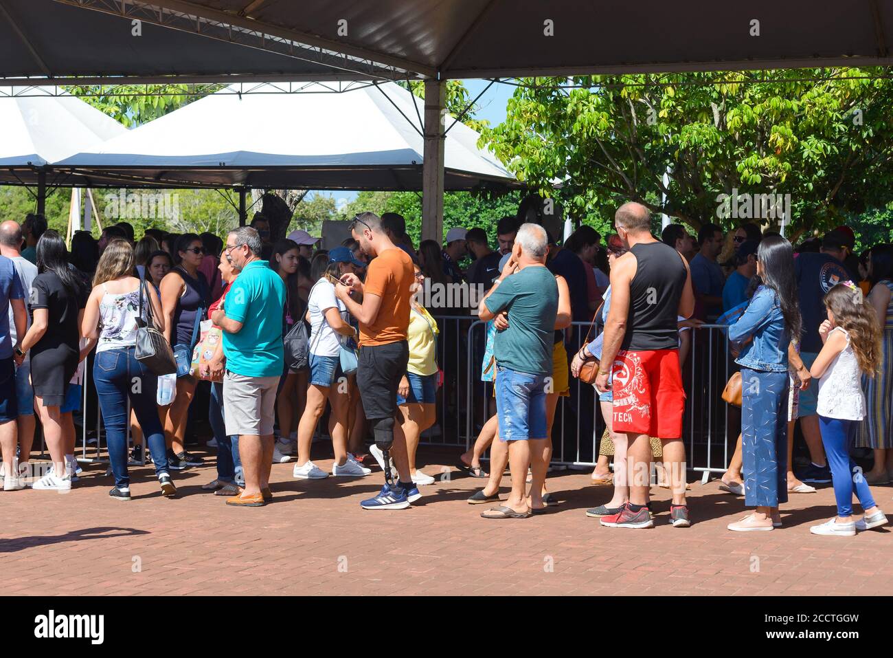 Long queue of tourists waiting to visit the Iguassu Falls in the Iguaçu National Park during Carnival holiday in Brazil, generating agglomeration line Stock Photo