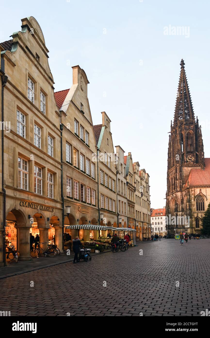 Muenster, historic  town, gabeld sandstone houses on Prinzipalmarkt with St. Lamberts Church, view over ancient cobblestone road, Germany, Western Eur Stock Photo