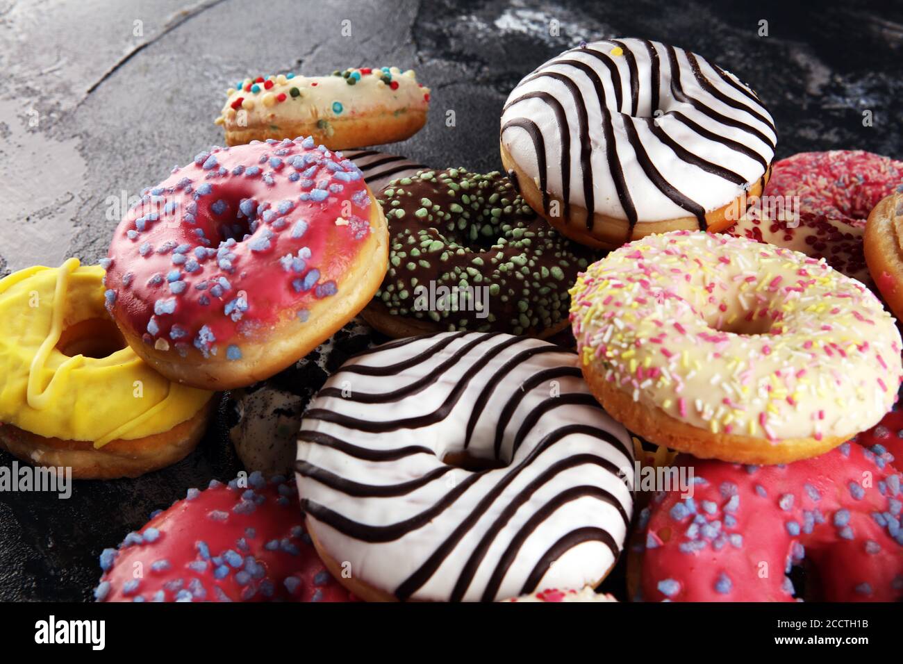 assorted donuts with chocolate frosted, pink glazed and sprinkles ...