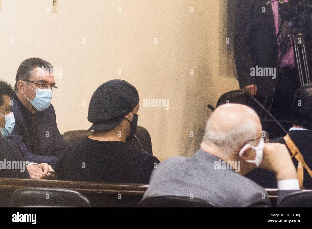 Asuncion, Paraguay. 24th Aug, 2020. The former Brazilian football star Ronaldinho (M.) and his brother Roberto de Assis Moreira (l) are sitting in court. The two-time world footballer and 2002 world champion and his brother were caught with false Paraguayan identity documents shortly after they entered Paraguay in March and spent more than 30 days in prison. Credit: Jorge Candia/dpa/Alamy Live News Stock Photo