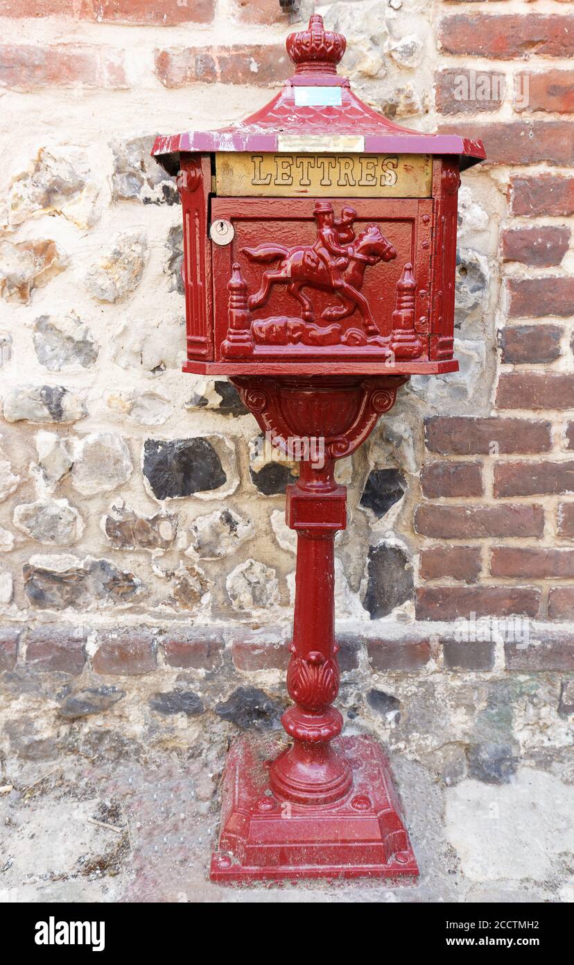old beautifully decorated post box with the inscription in french language . Stock Photo