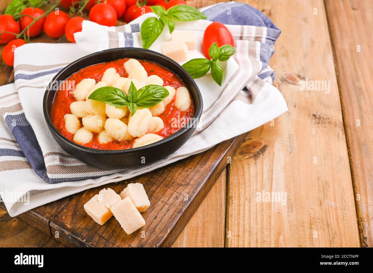 Homemade Italian Gnocchi with Red Sauce, Cheese with basil, olive oil . Close up. Home cooking. Traditional Italian cuisine from Rome and Sardinia. Plate of food for the first Stock Photo
