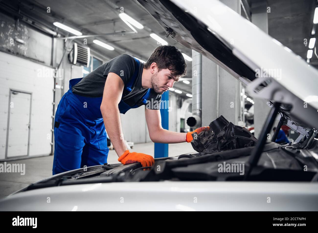 Man opens the hood and checks the car engine Stock Photo - Alamy