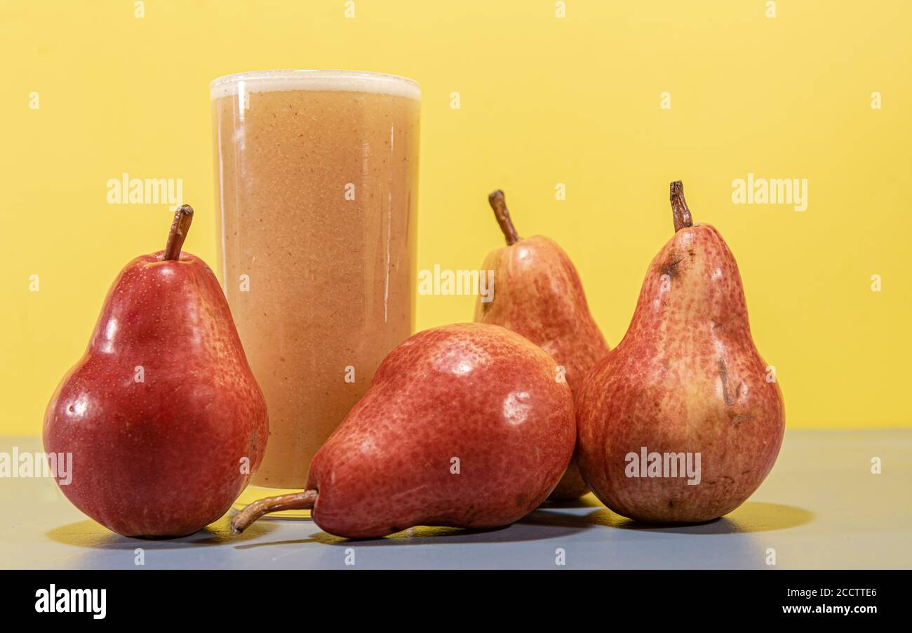 Red Pear Juice. Natural drink. Fruit drink. Fruit from the USA and Canada. Red Pear, also known as Red Williams or Red Barlett. It presents a dark red Stock Photo